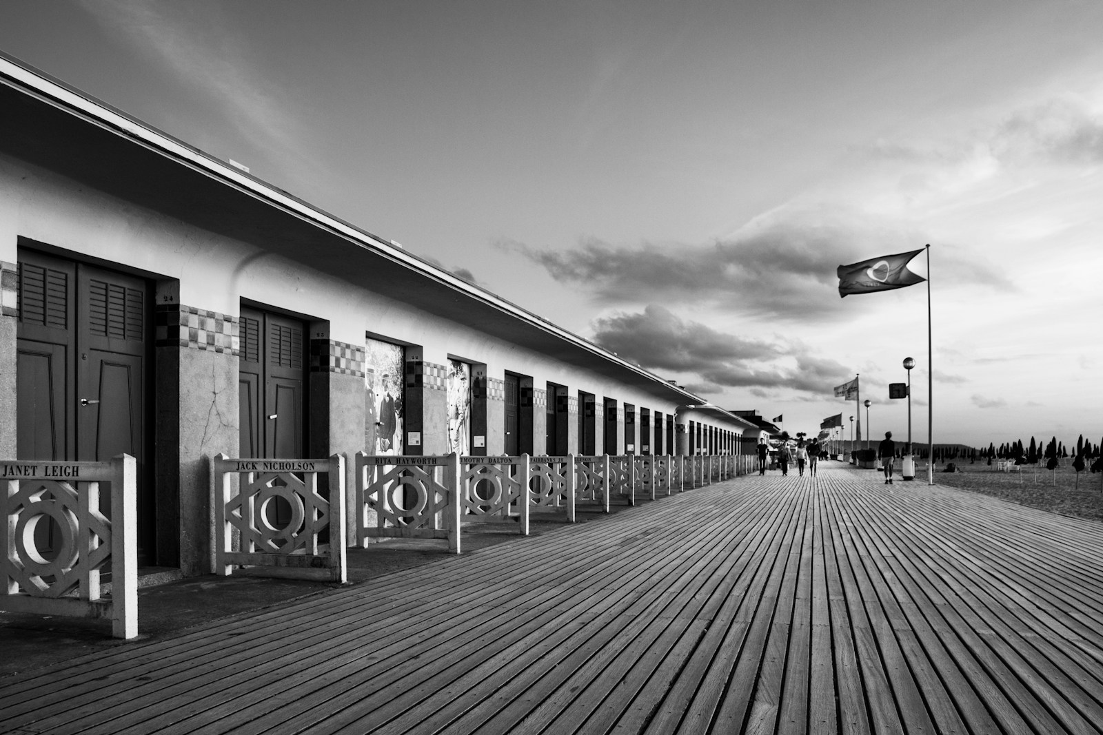 grayscale photo of people walking on sidewalk